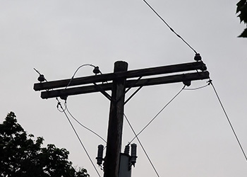 Utility pole with missing wires.