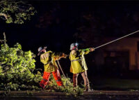 Two utility workers holding the line.